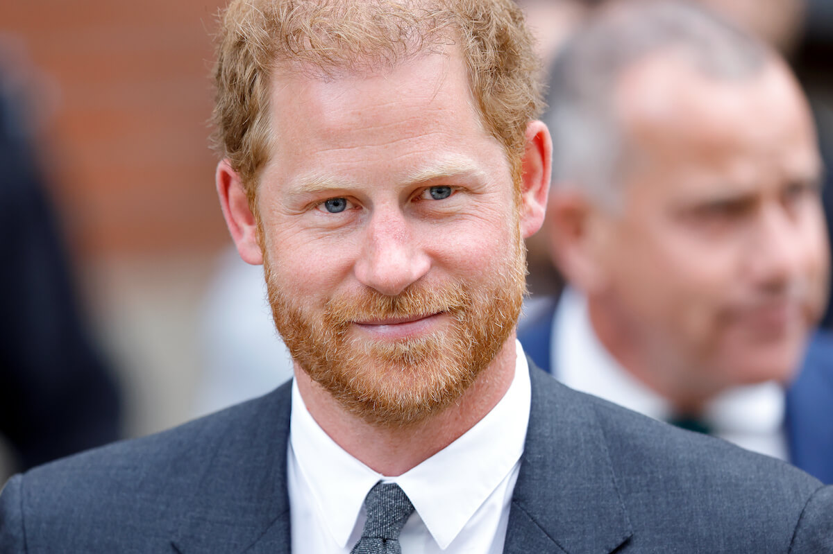 Prince Harry, who will have no official coronation role, looks on