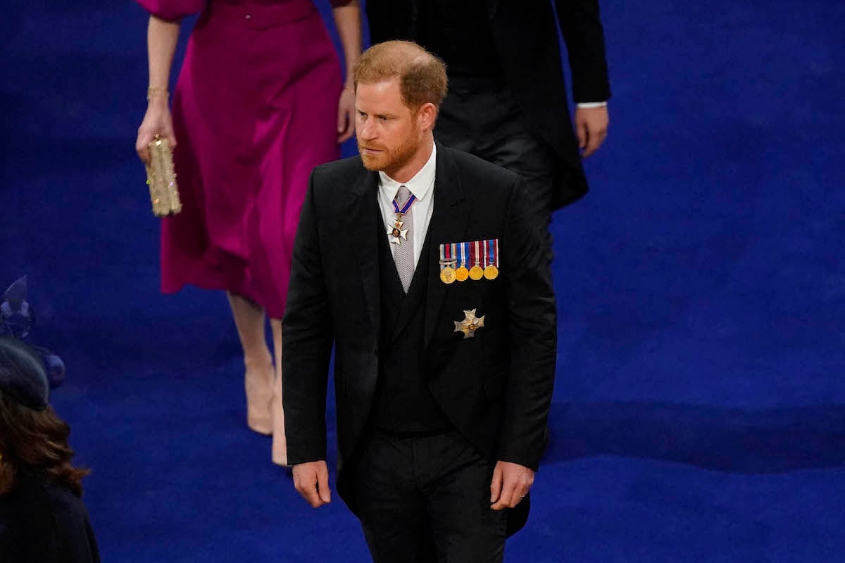Prince Harry, whose coronation attendance may have marked the 'beginning of the end' for royal family 'interaction,' walks to his seat in Westminster Abbey