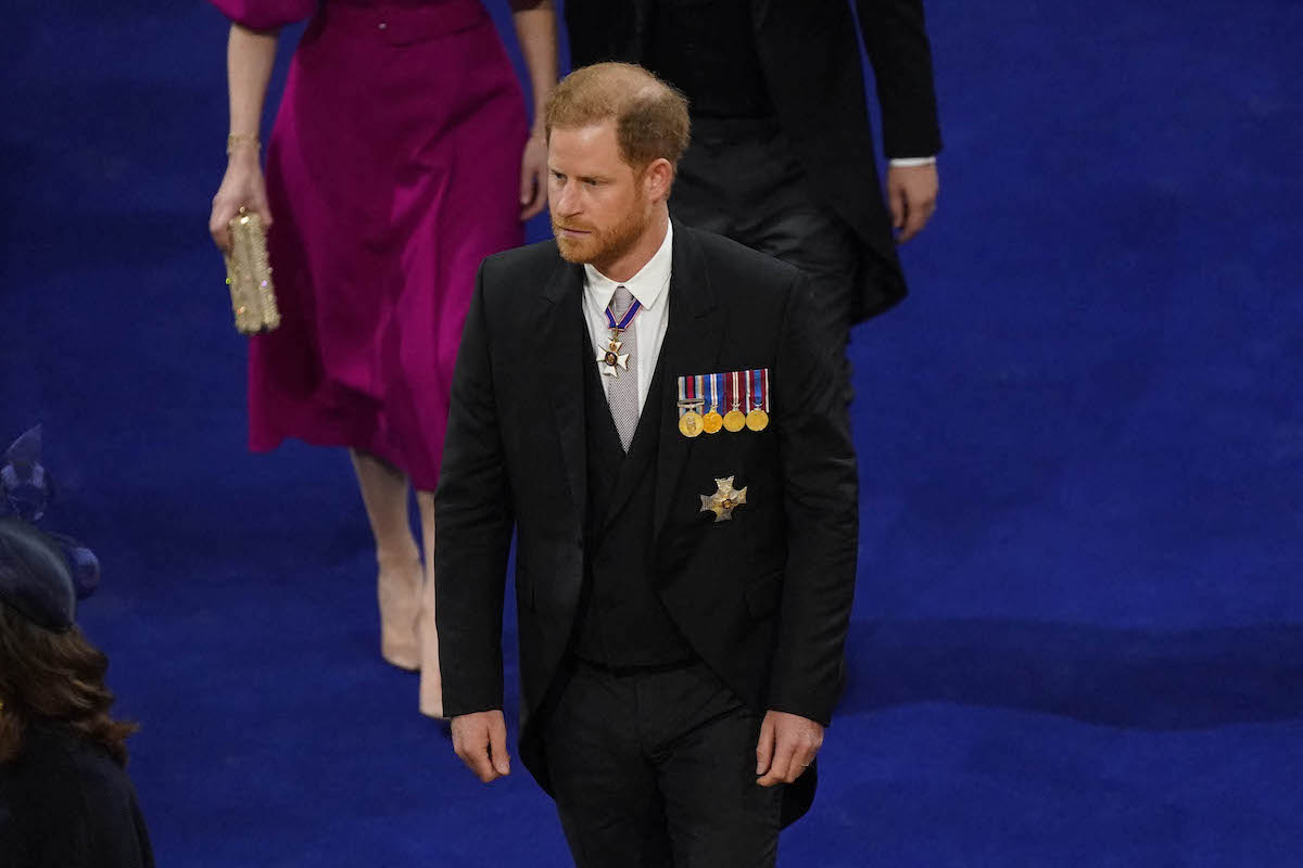 Prince Harry, whose coronation attendance may have marked the 'beginning of the end' for royal family 'interaction,' walks to his seat in Westminster Abbey