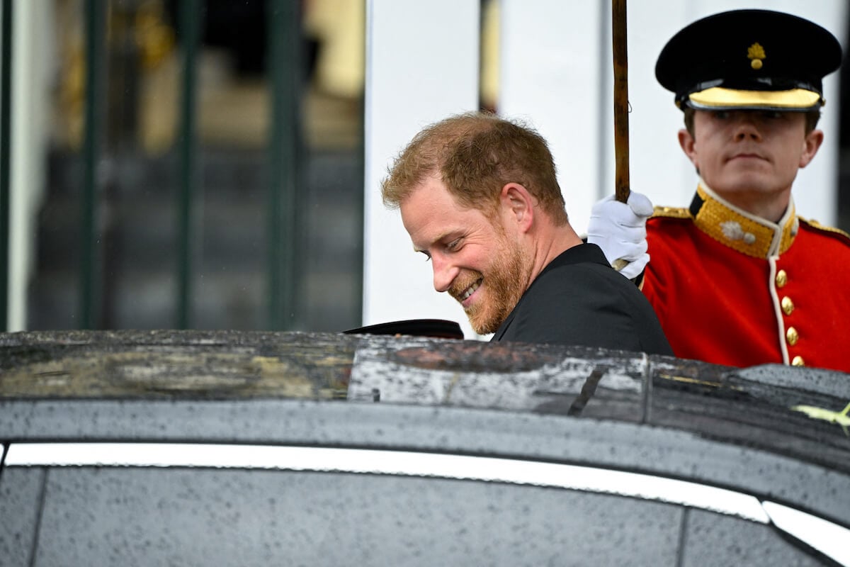 Prince Harry, whose short coronation visit 'saddened' King Charles, smiles as he gets in a car after the coronation