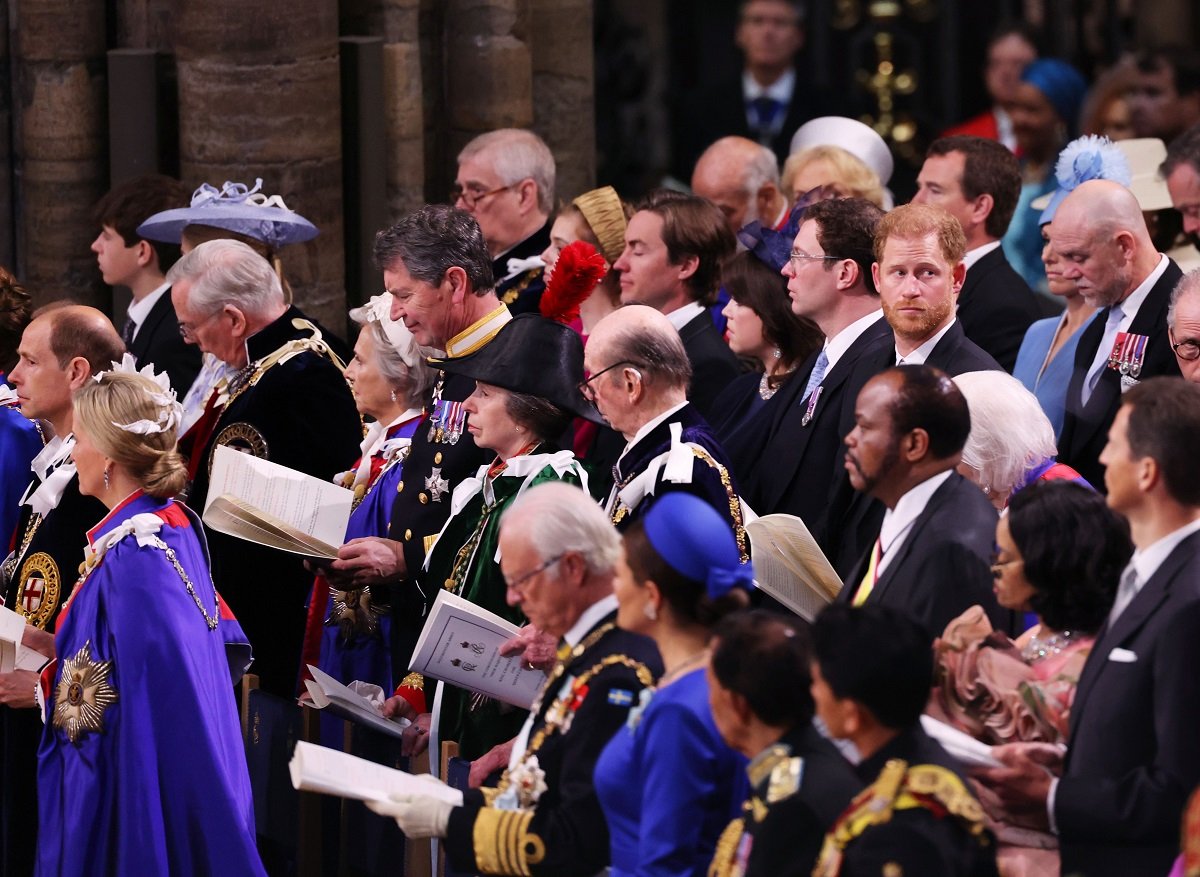 Prince Harry with his head turned to the side during the coronation ceremony of King Charles III
