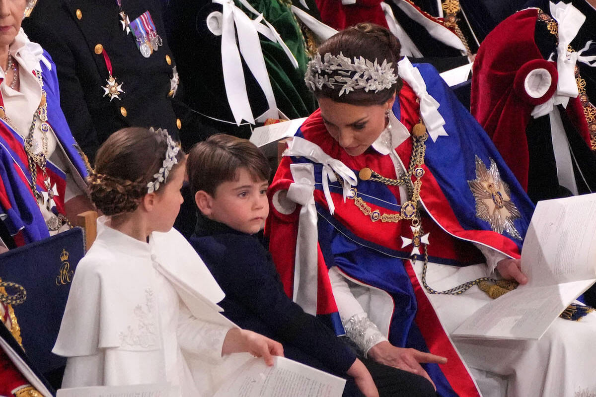 Kate Middleton, whose 'biggest worry' at the coronation was Prince Louis, leans over to talk to Prince Louis and Princess Charlotte at Westminster Abbey