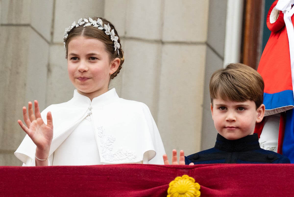 Prince Louis, who Kate Middleton and Prince William talked to during the balcony appearance, stands next to Princess Charlotte