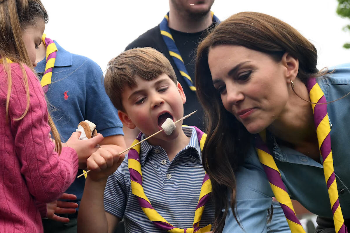 Prince Louis, who had memorable coronation weekend facial expressions, eats a marshmallow next to Kate Middleton and Princess Charlotte