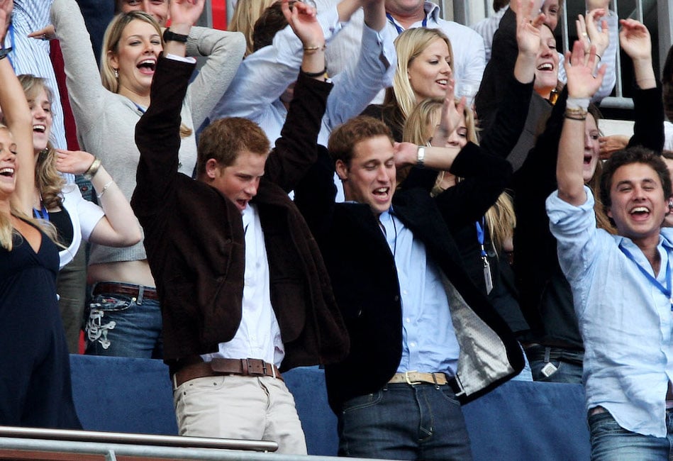 Prince Harry and Prince William dance excitedly at a concert to honor their mother, Princess Diana, in 2007