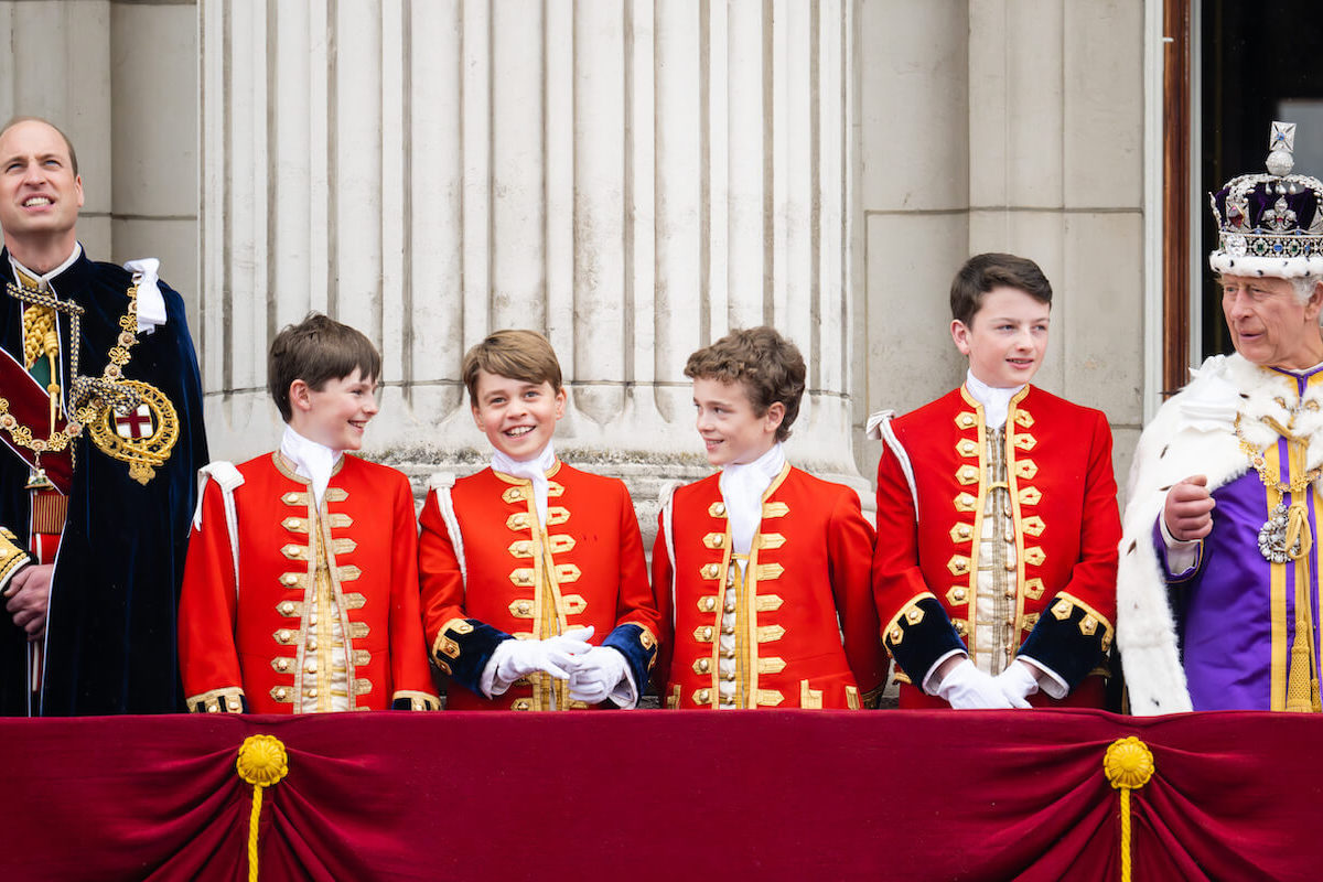 Prince William and Prince George, who appeared in a coronation portrait with King Charles, stand on the Buckingham Palace balcony with page boys after coronation