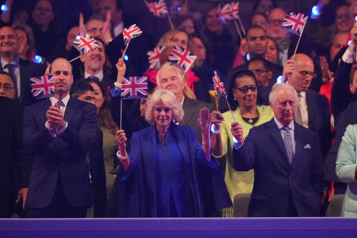 Prince William, who gets along better with his father and stepmother because of Kate Middleton, according to a biography, stands with Queen Camilla and King Charles