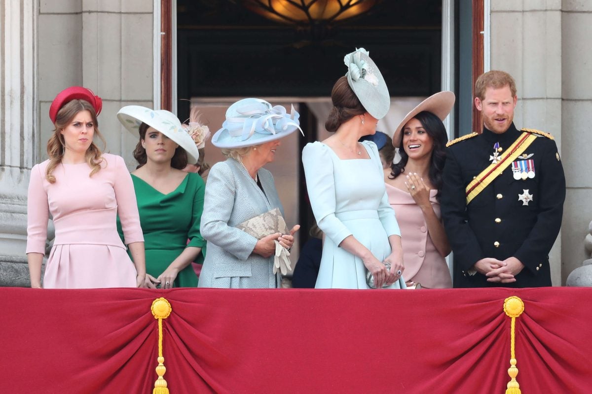 Princess Beatrice, Princess Eugenie, Meghan Markle, Prince Harry, and other members of the royal family standing on the balcony of Buckingham Palace