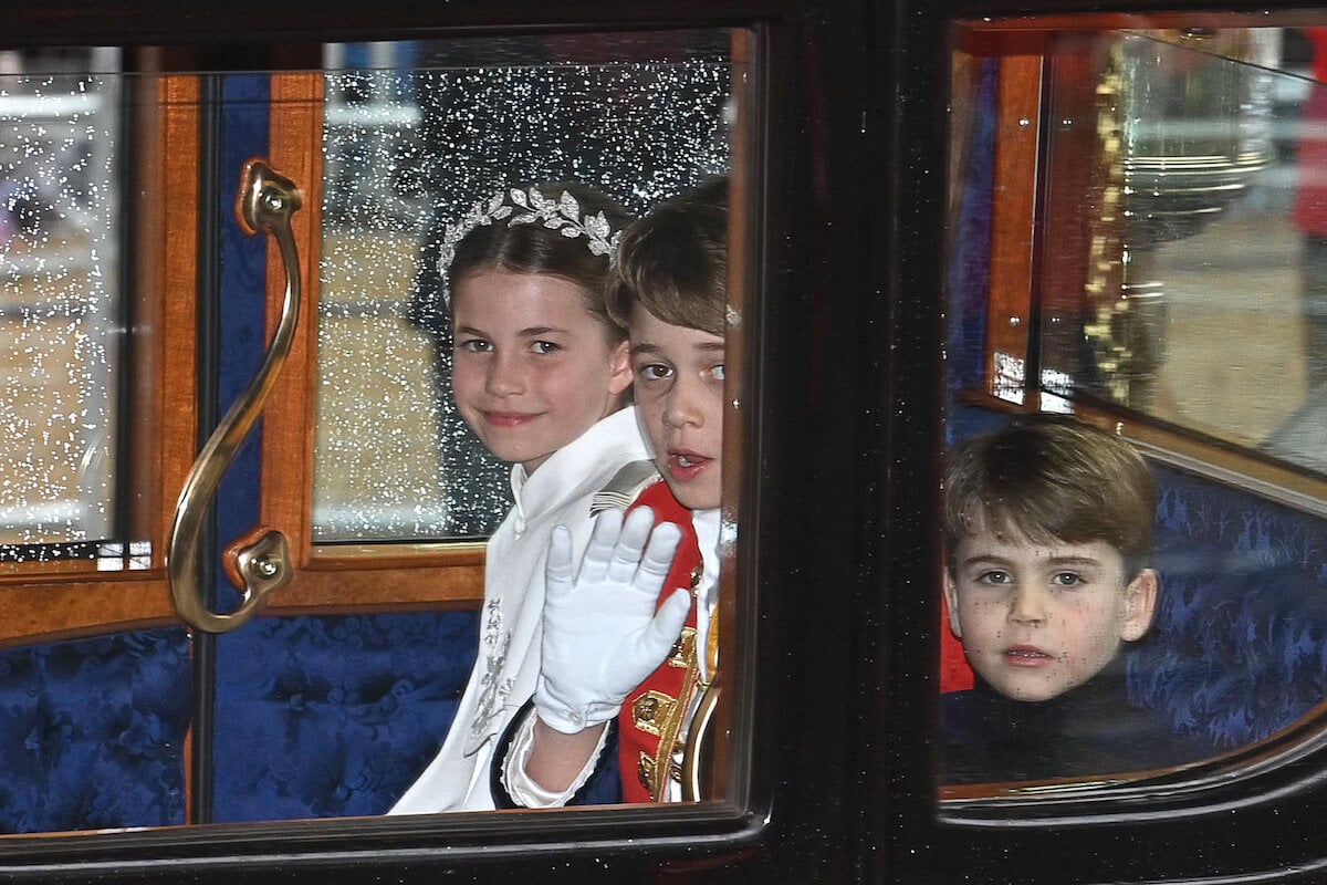 Princess Charlotte, Prince George, and Prince Louis, who had varied coronation weekend facial expressions, in the carriage procession