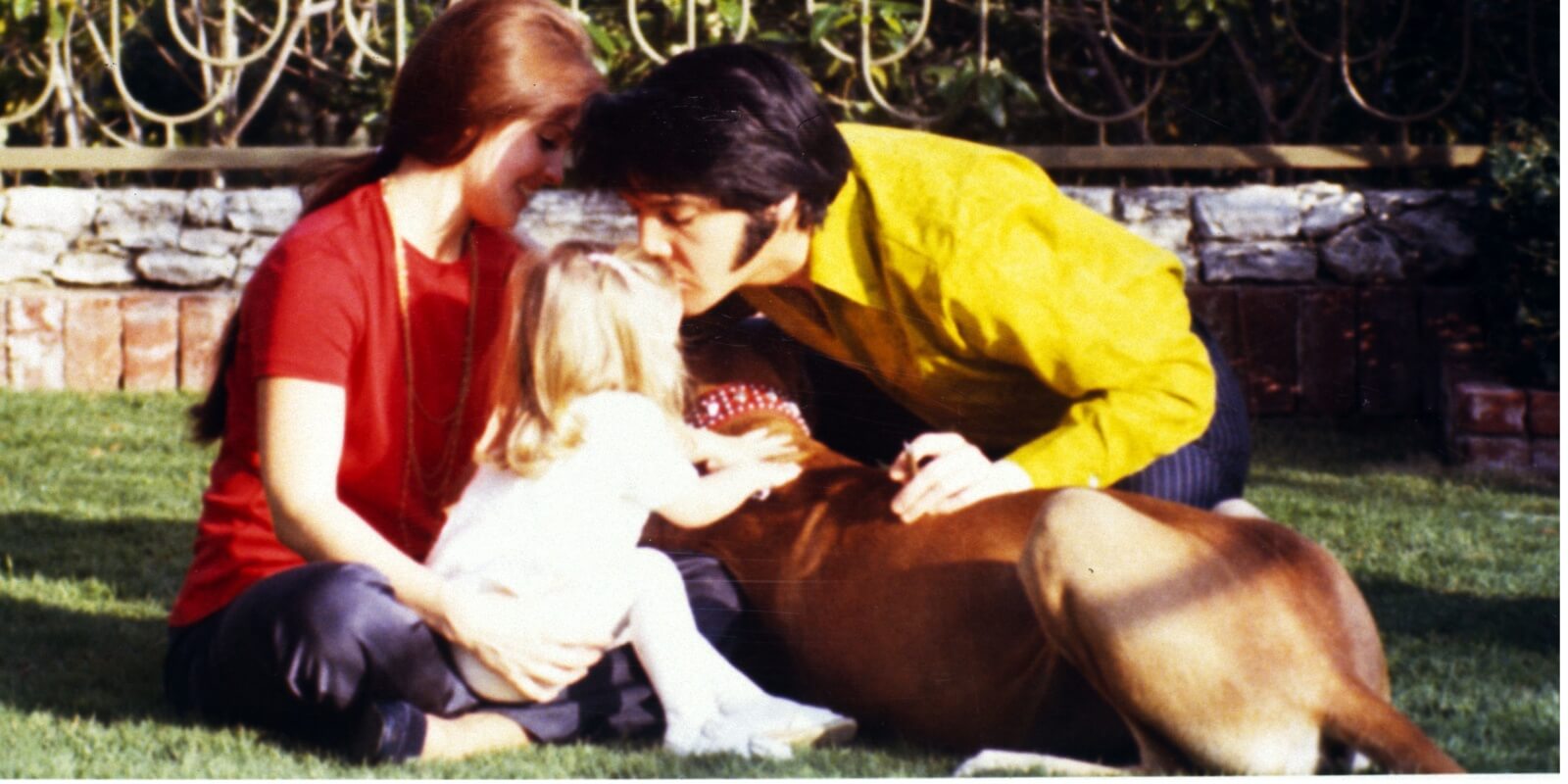 Priscilla Presley, Elvis Presley and Lisa Marie on the grounds of his Graceland estate.