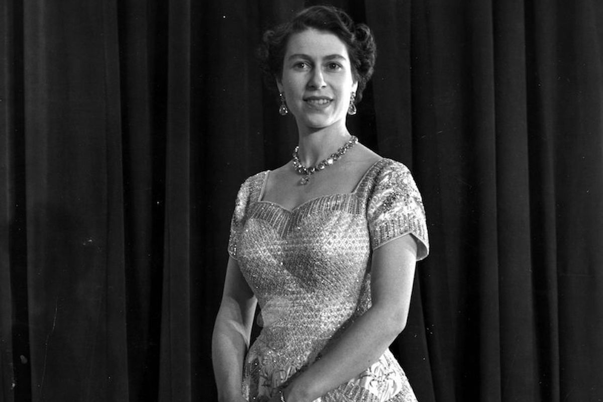 Queen Elizabeth II wears her coronation dress and smiles