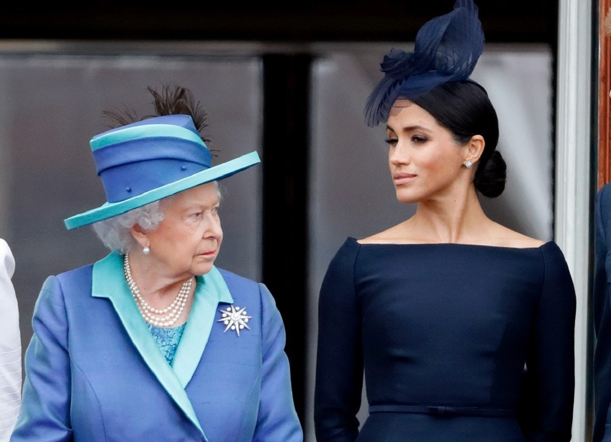 Queen Elizabeth II with Meghan Markle, who she reportedly called evil watching a flypast together on the Buckingham Palace balcony