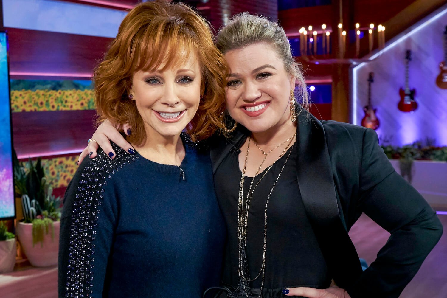 'The Voice' coaches Reba McEntire and Kelly Clarkson hugging each other and smiling