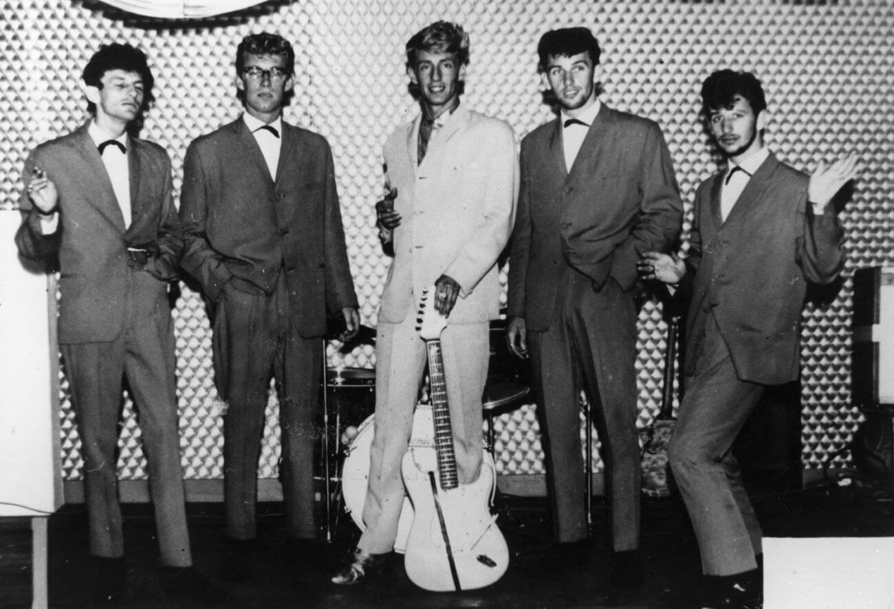 A black and white pictures of the members of Rory Storm & the Hurricanes posing onstage.