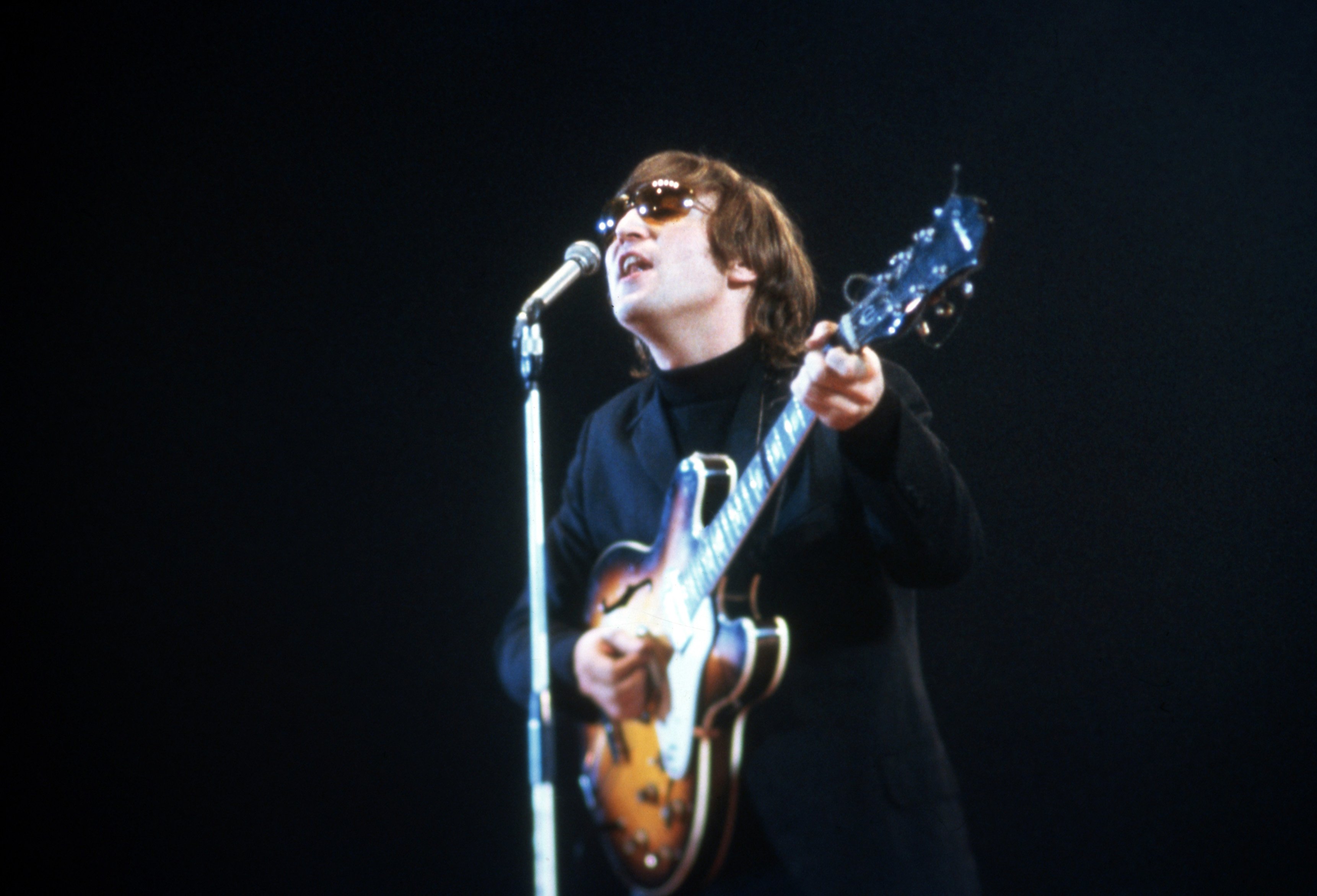John Lennon of The Beatles performs at the NME Awards in 1966 in London, UK