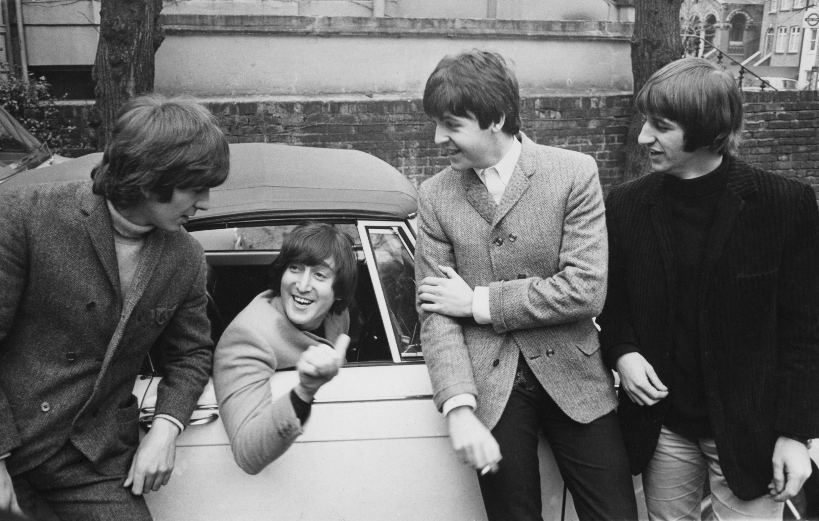 The Beatles congratulate John Lennon after he passes his driver's test