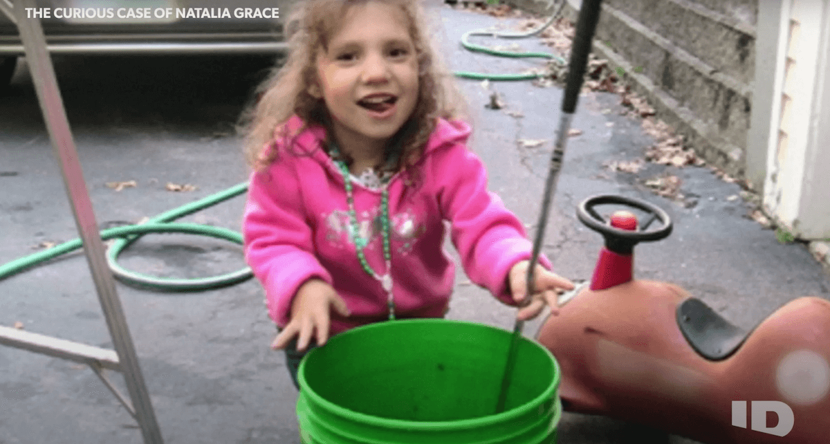 Young Natalia Grace wearing a pink sweatshirt in 'The Curious Case of Natalia Grace' on ID