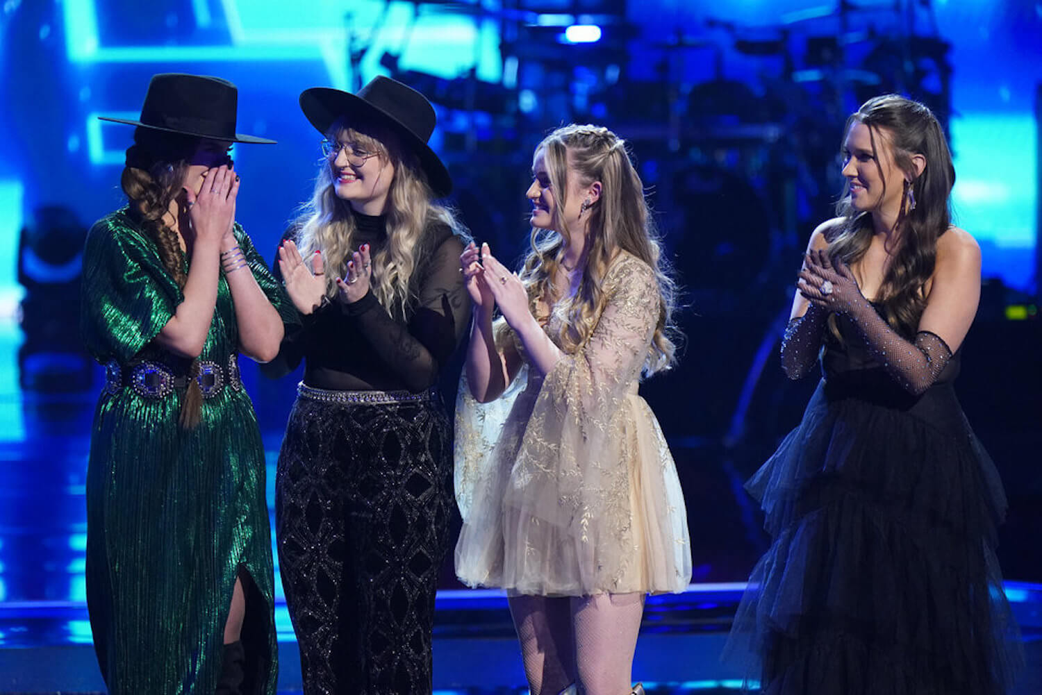 Grace West, Kylee Dayne, Mary Kate Connor, and Rachel Christine standing on stage in 'The Voice' Season 23 for the top 8