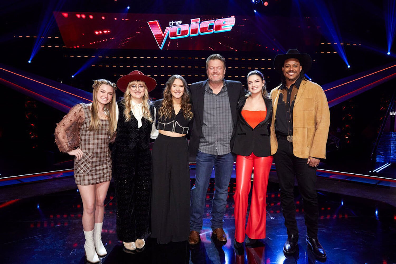 Blake Shelton standing on a stage with 'The Voice' Season 23 contestants ahead of the Playoffs