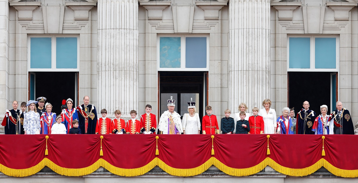 Working members of the royal family along with pageboys and Camilla Parker Bowles' friend and her sister standing on the balcony of Buckingham Palace