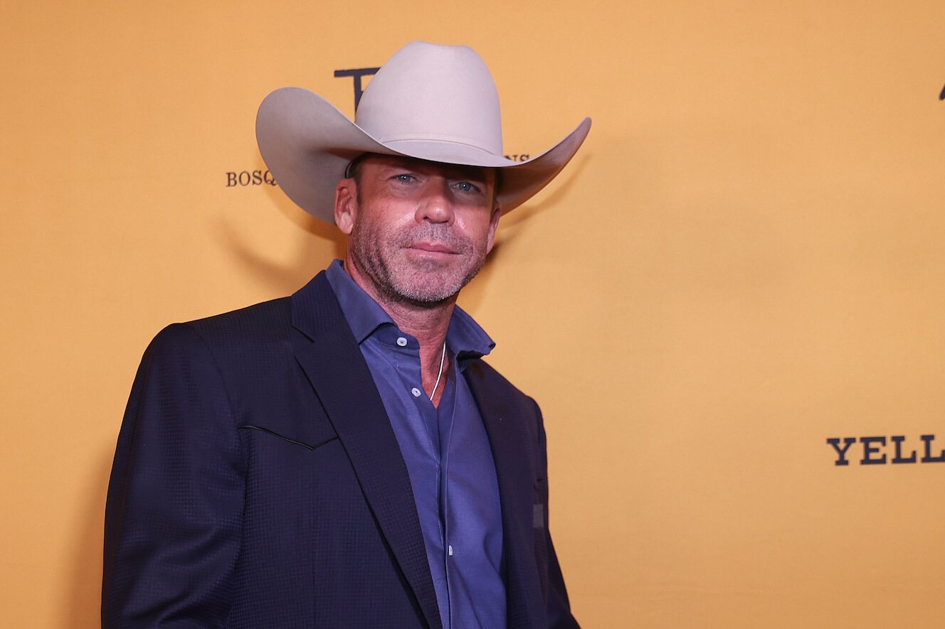'Yellowstone' screenwriter Taylor Sheridan wearing a cowboy hat against a yellow background