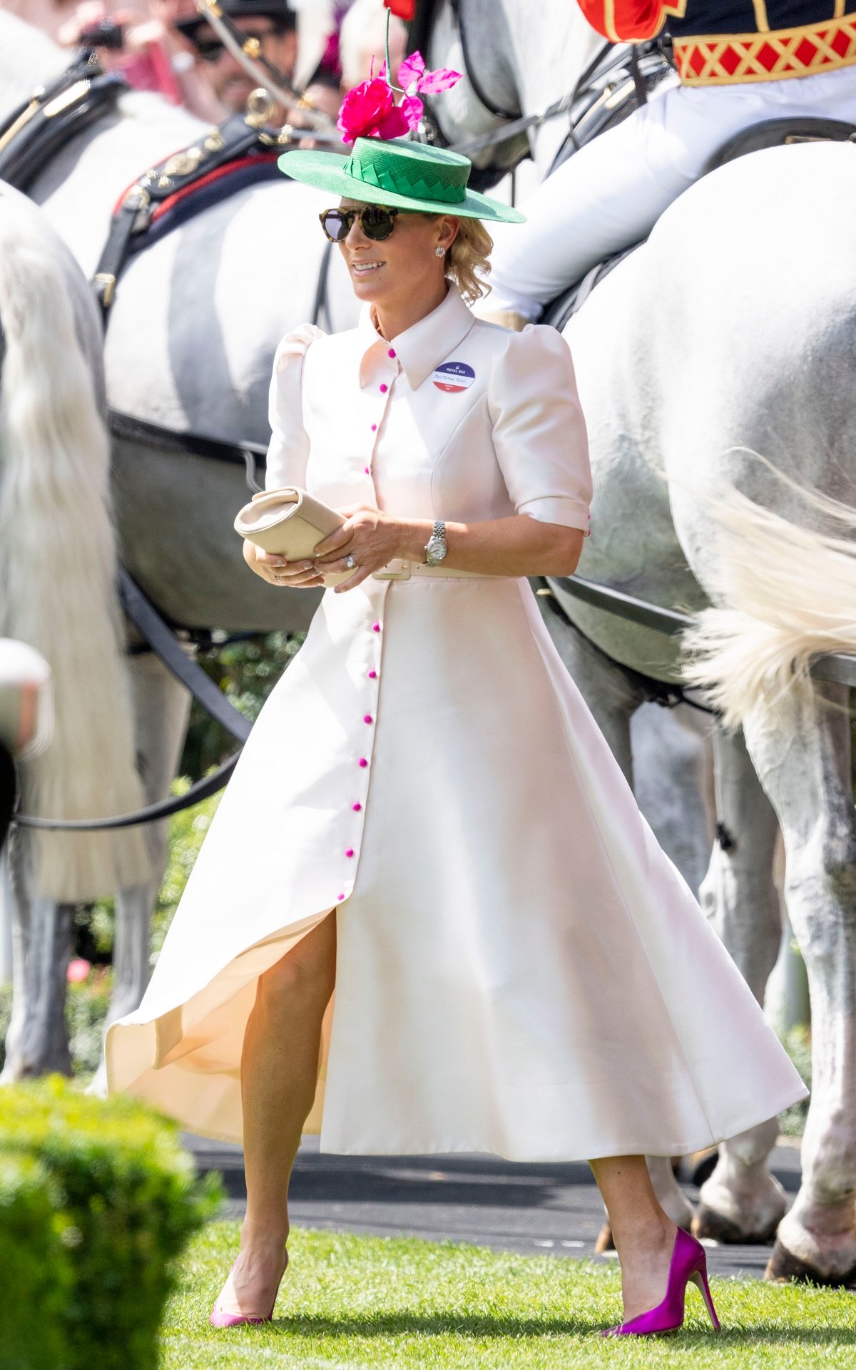 Zara Tindall standing in white dress and heels at Ascot Racecourse