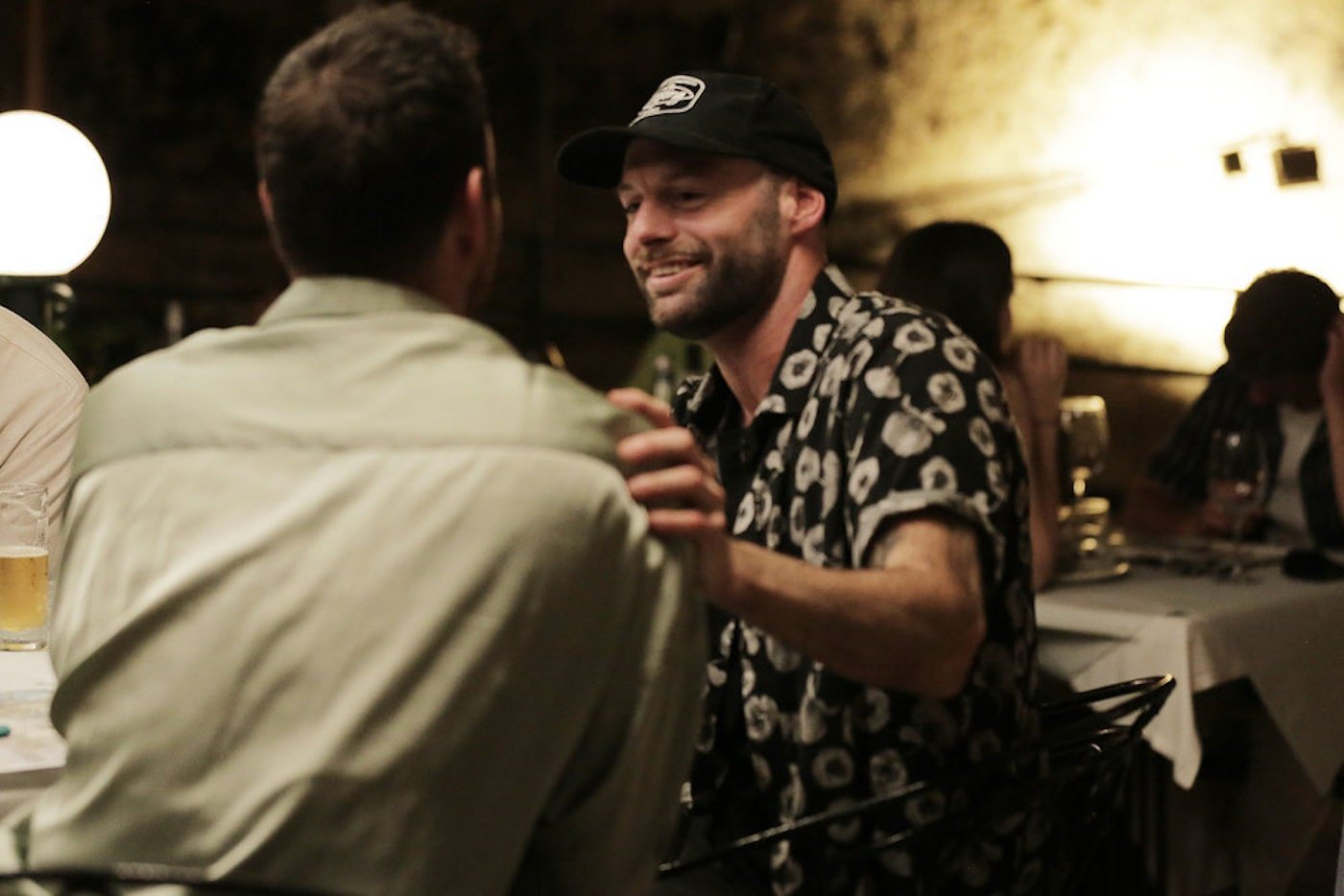 Chef Dave White smiles at another 'Below Deck Med' crew member while at dinner. 