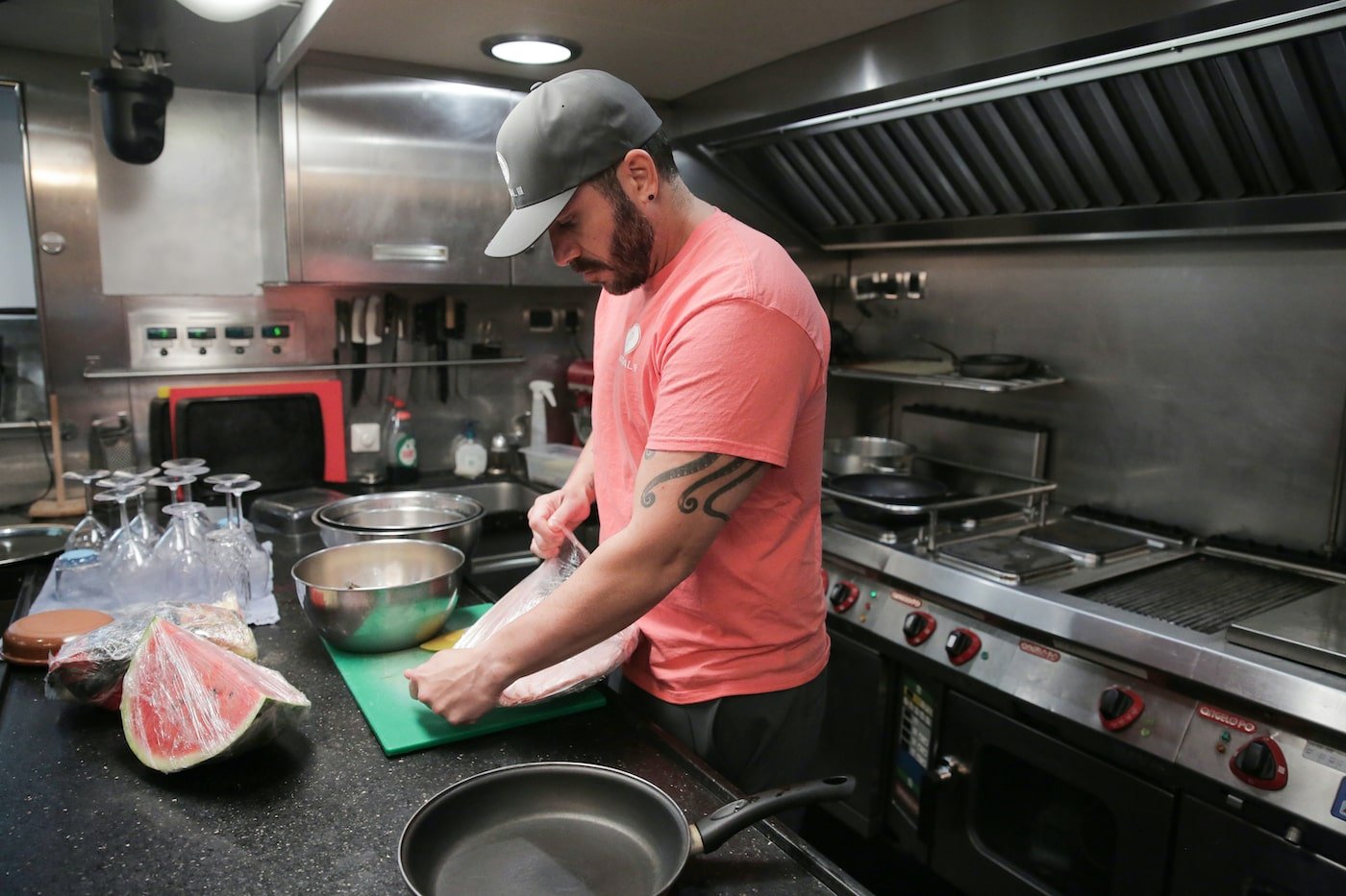 Chef Marcos Spaziani from 'Below Deck Sailing Yacht' opens food in the galley