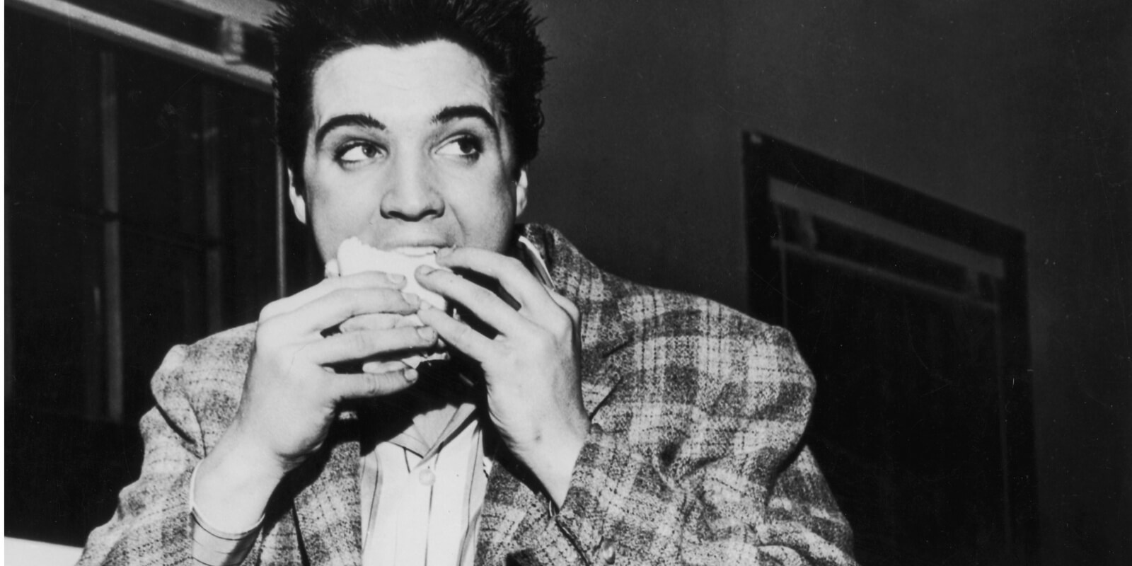 Elvis Presley eating a sandwich in 1958.