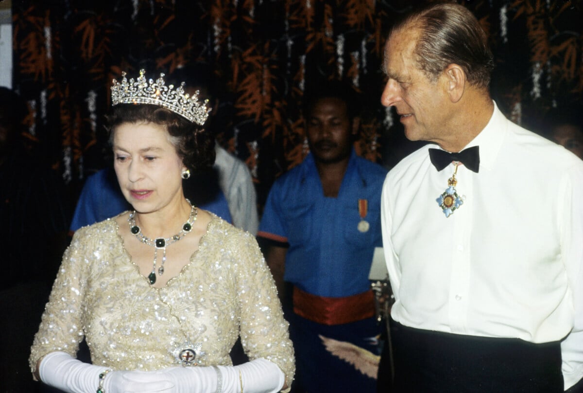 Queen Elizabeth ll and Prince Philip, Duke of Edinburgh attend a State Banquet on October 13, 1982 in Papua New Guinea. The Queen wears the Girls of Great Britain and Ireland diamond tiara and an emerld necklace and earrings known as the Cambridge and Delhi Durbar Parure