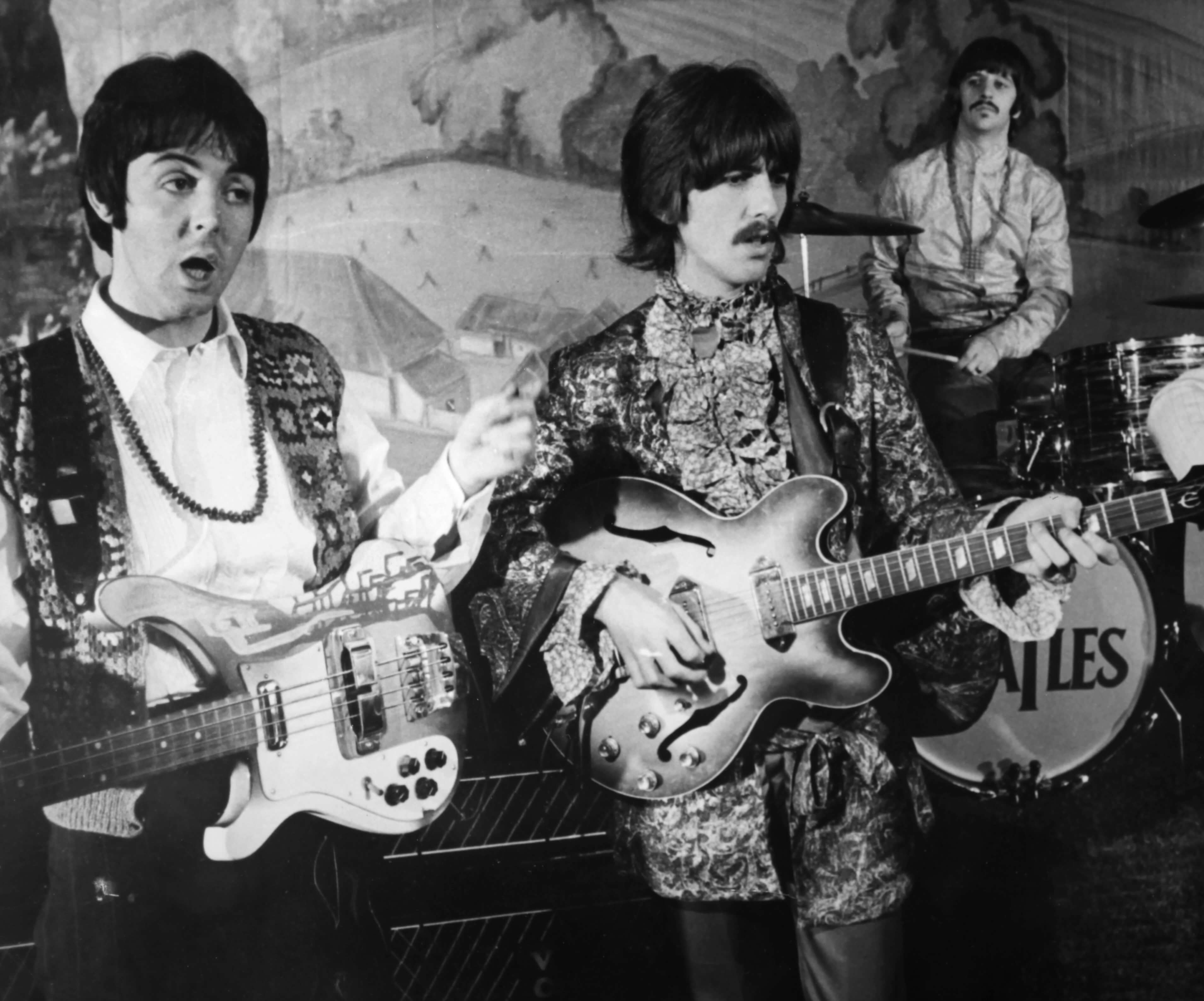 Paul McCartney, George Harrison, and Ringo Starr playing instruments during The Beatles' "Strawberry Fields Forever" era