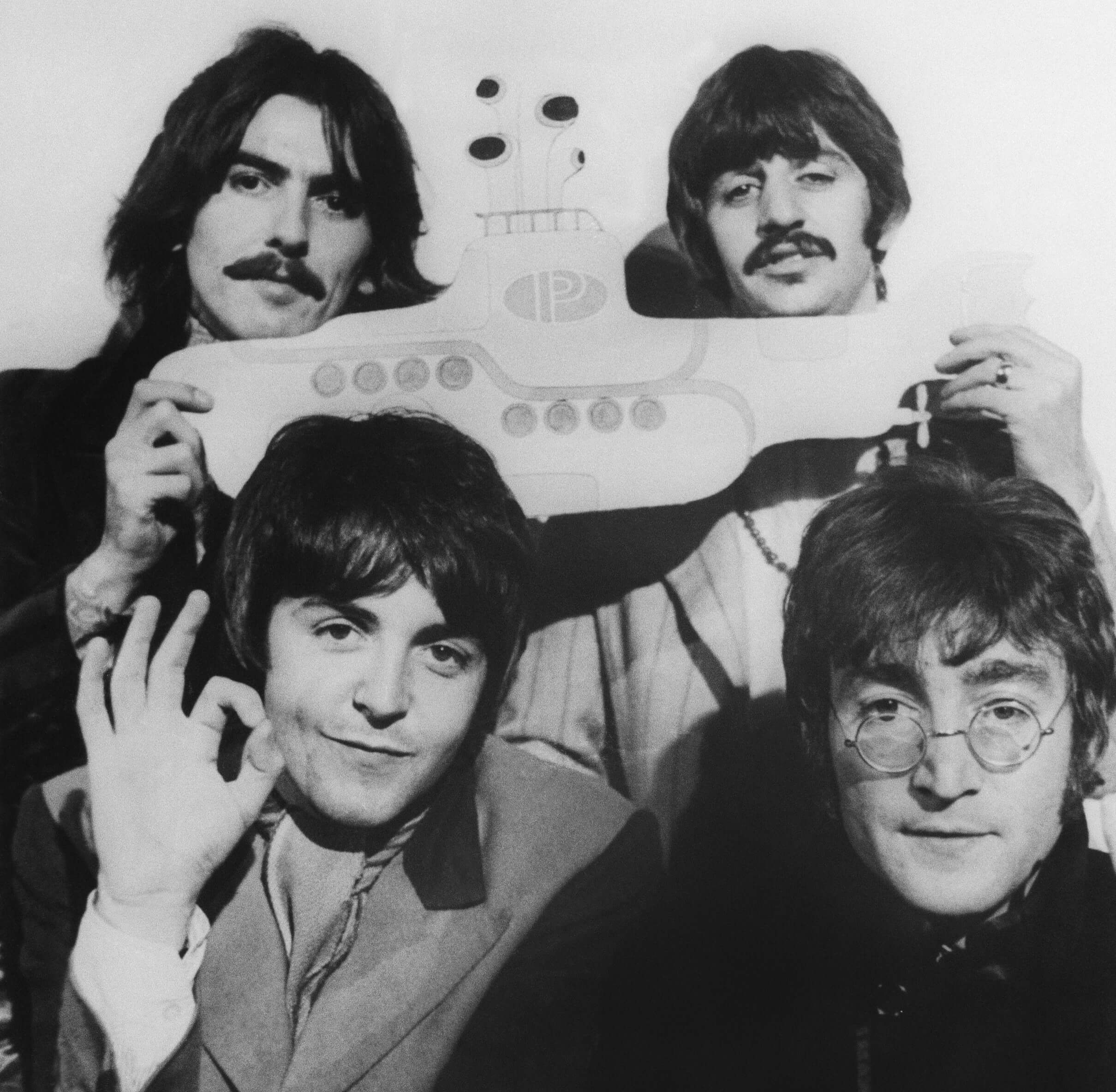 The Beatles with a yellow submarine in black-and-white