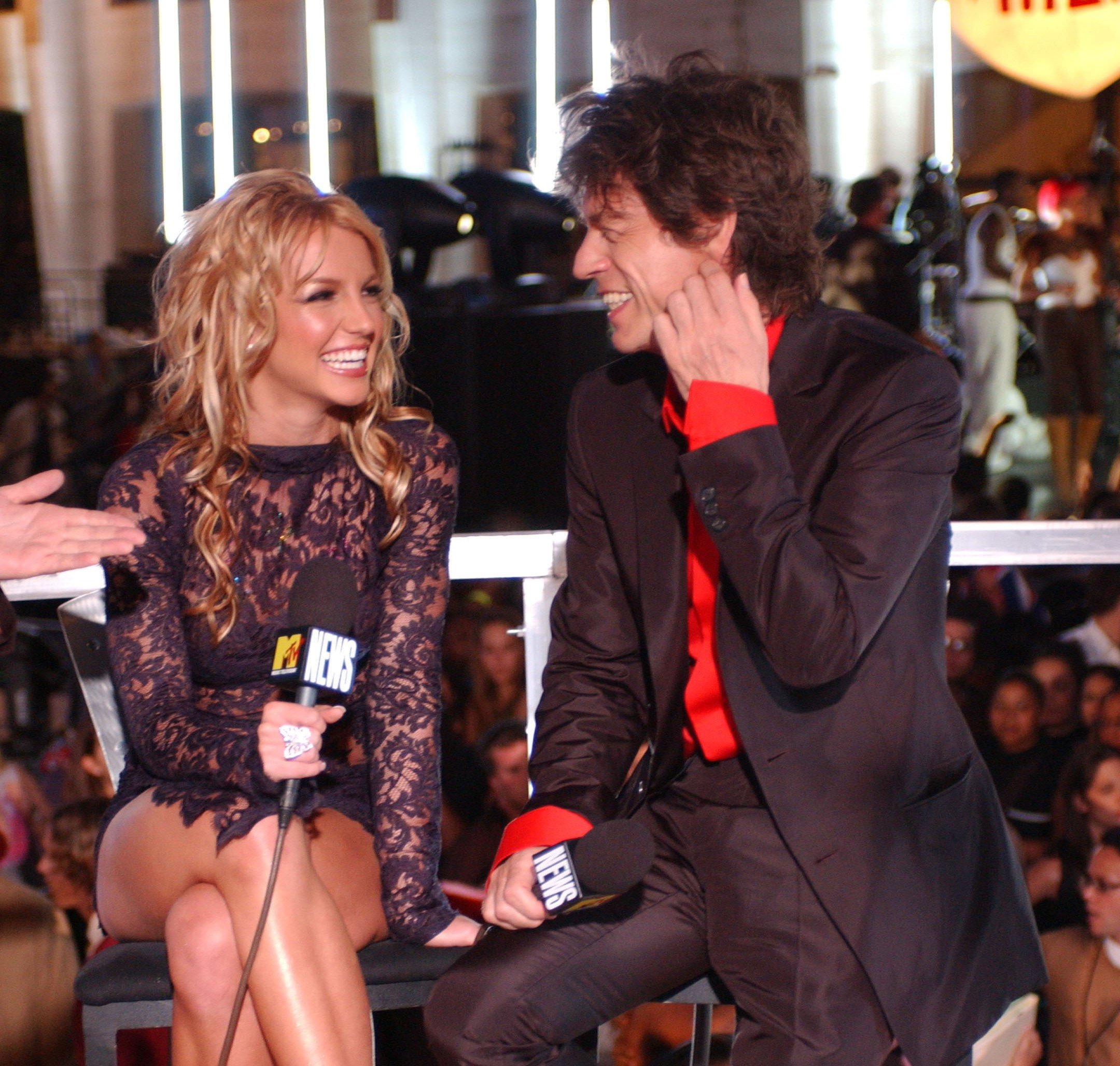 Britney Spears and The Rolling Stones' Mick Jagger sitting next to each other