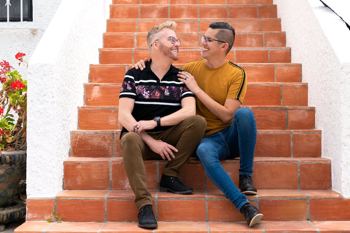Kenny and Armando from '90 Day Fiance: The Other Way' sitting on steps