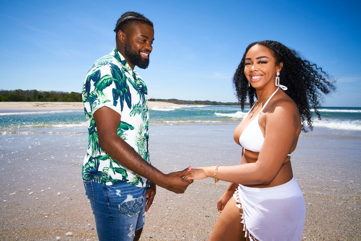 Alexis & Devon from 'The Big D' holding hands on the beach