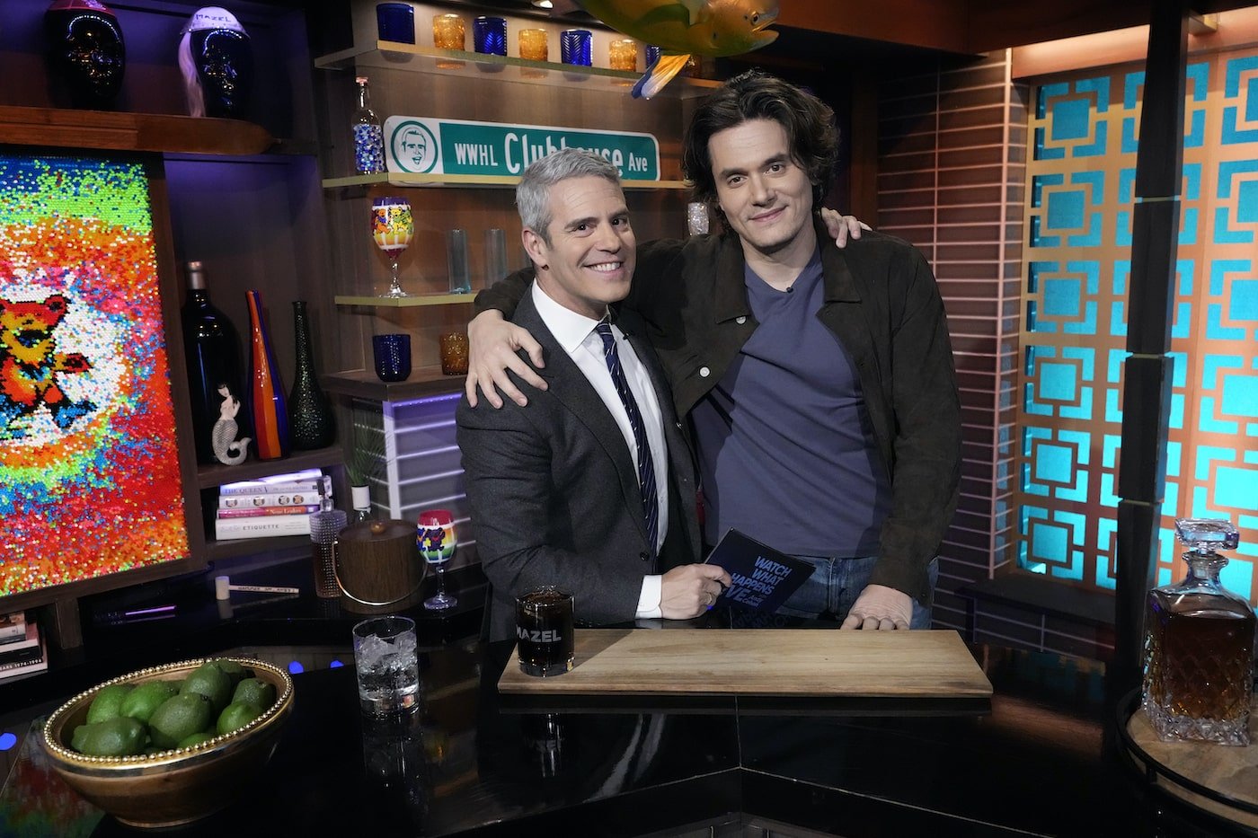 Andy Cohen and John Mayer pose behind the WWHL bar
