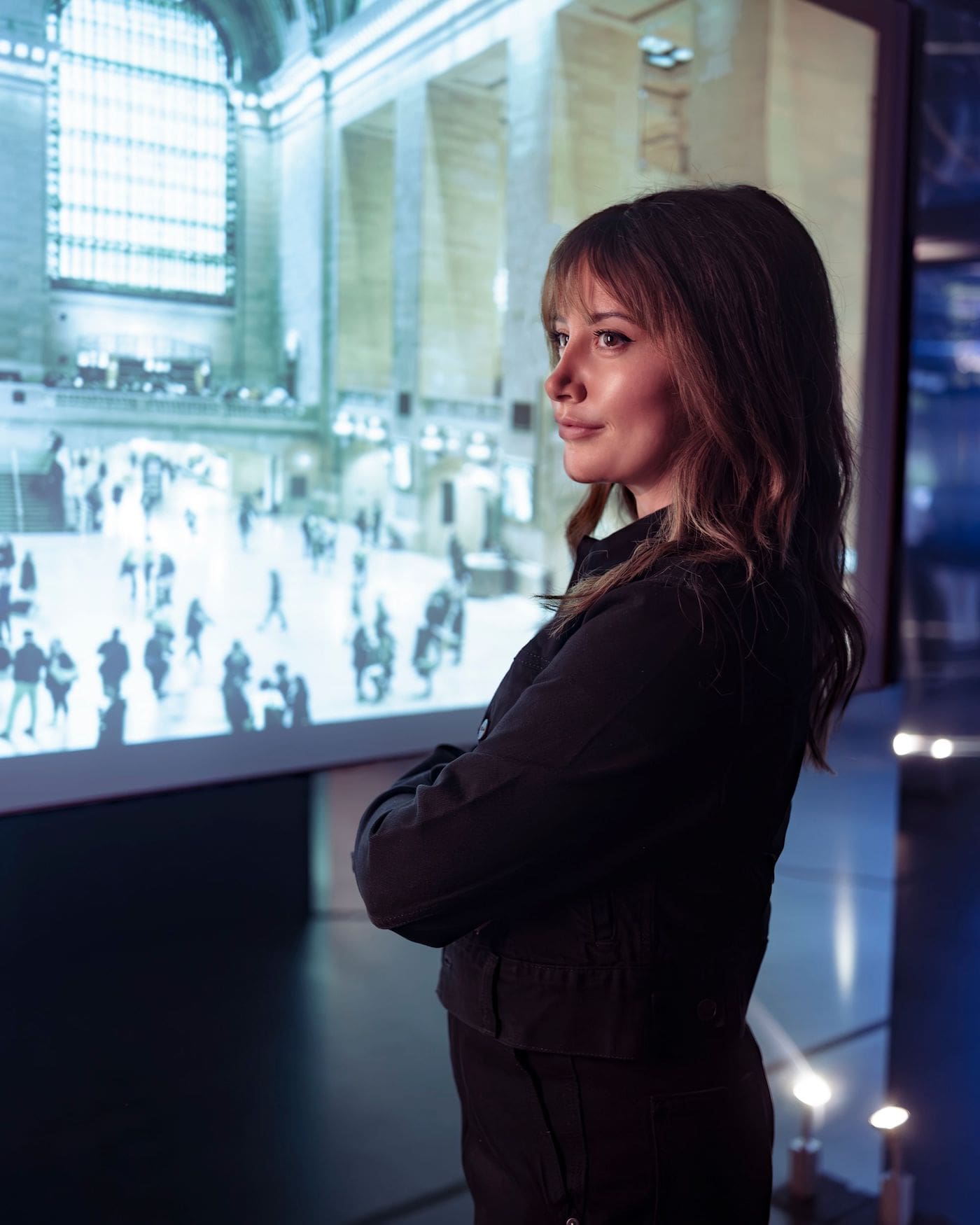 Ashley Tisdale looks over Grand Central Station with arms folded