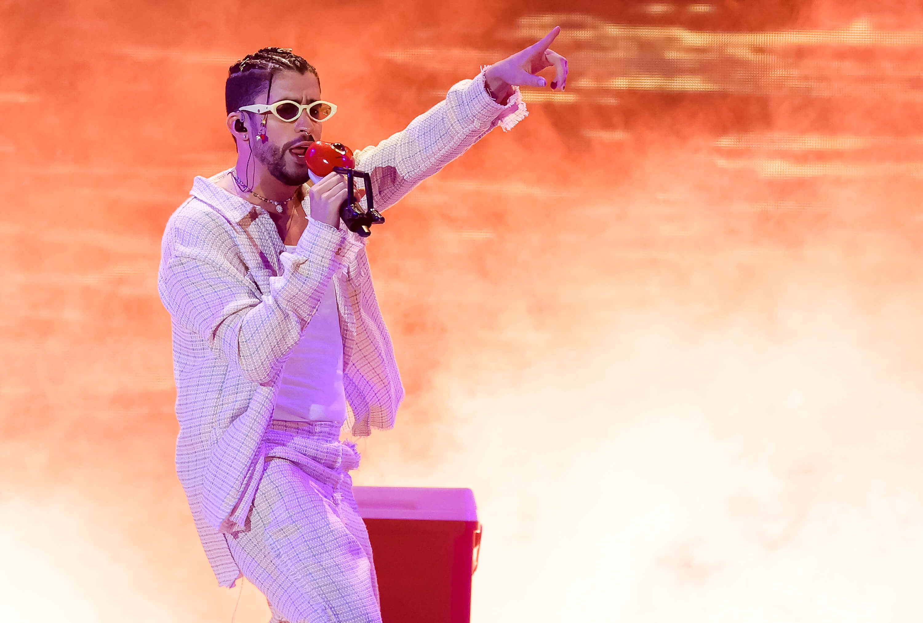 Bad Bunny on stage, pointing.