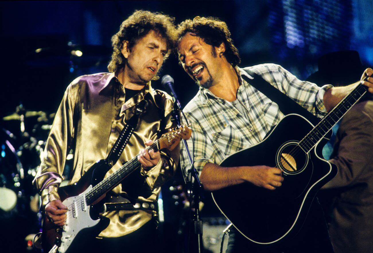 Bob Dylan and Bruce Springsteen play guitars and sing into the same microphone.