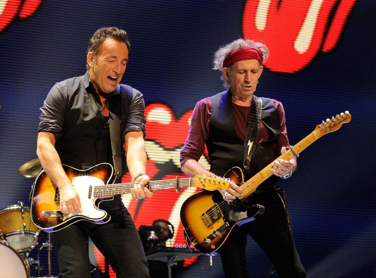 Bruce Springsteen and Keith Richards play guitars on stage together.