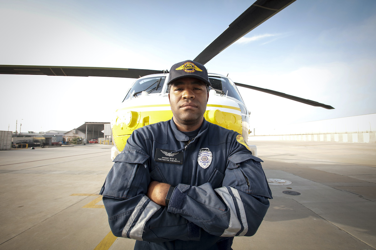 A man standing in front of a helicopter in 'LA Fire & Rescue' on NBC