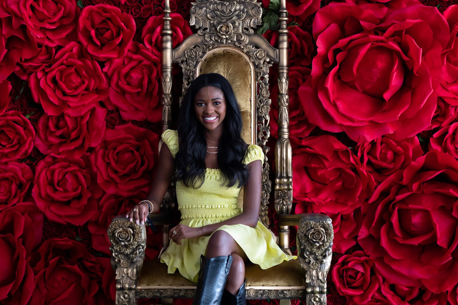 'The Bachelorette' 2023 star Charity Lawson sitting in a throne against a red rose background