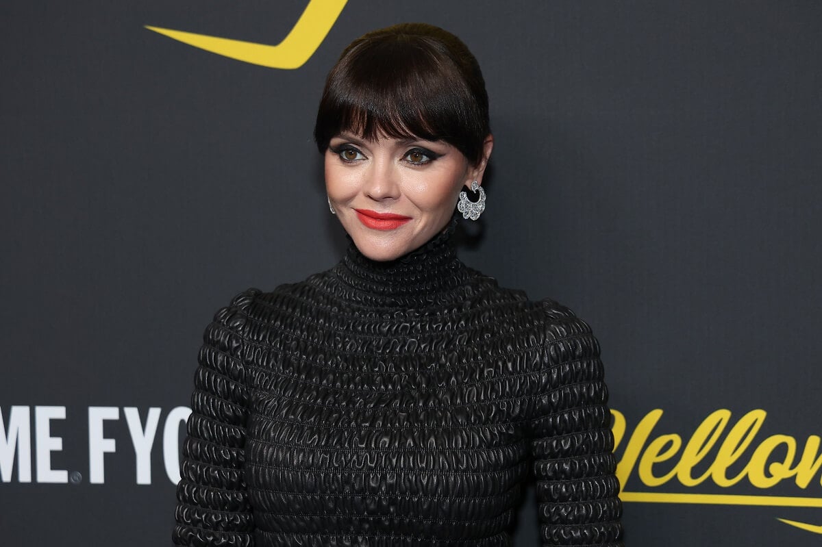 Christina Ricci posing in a black dress at the season 2 premiere of 'Yellowjackets'.