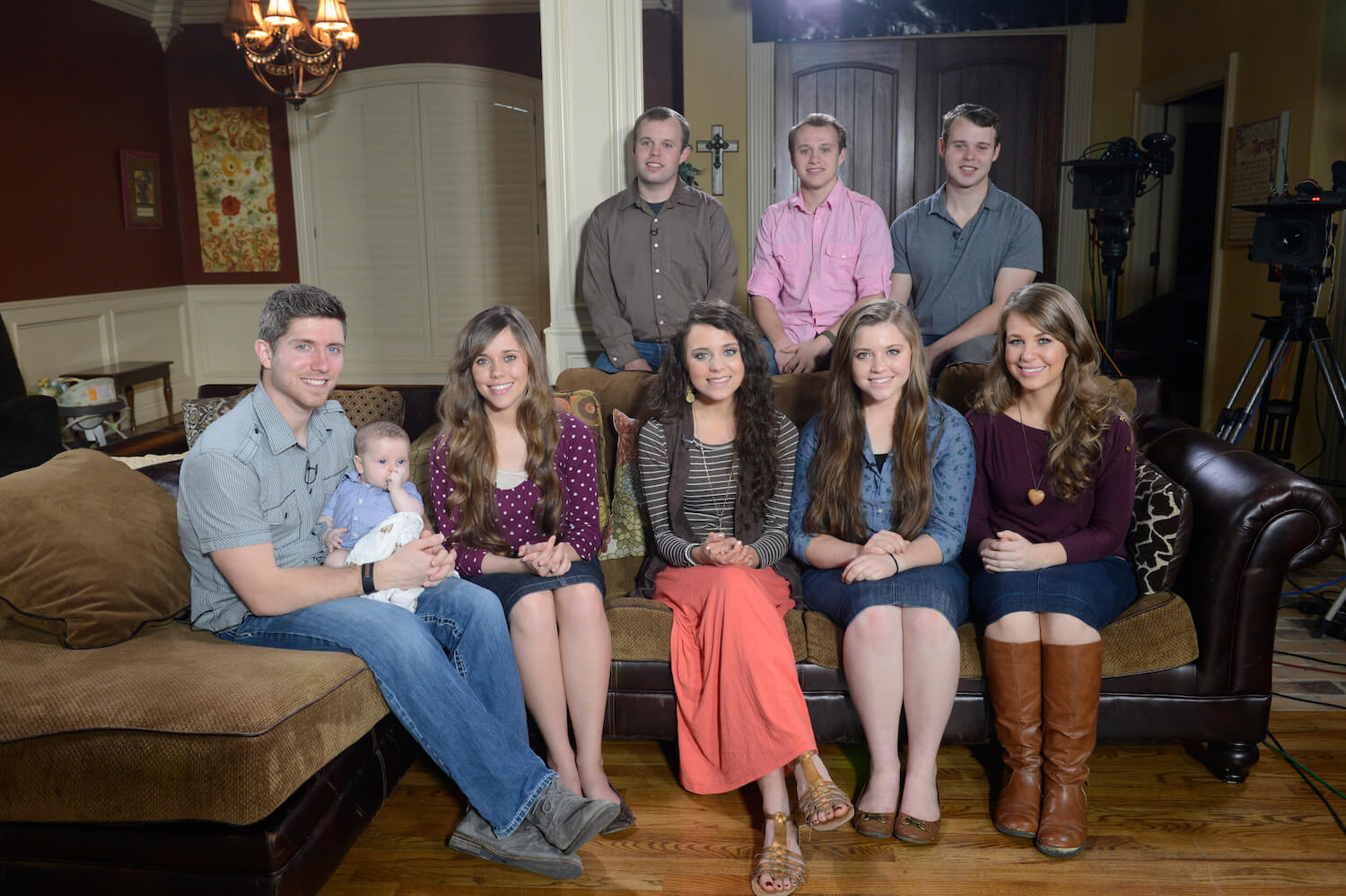 Duggar family members standing sitting to pose for a photo