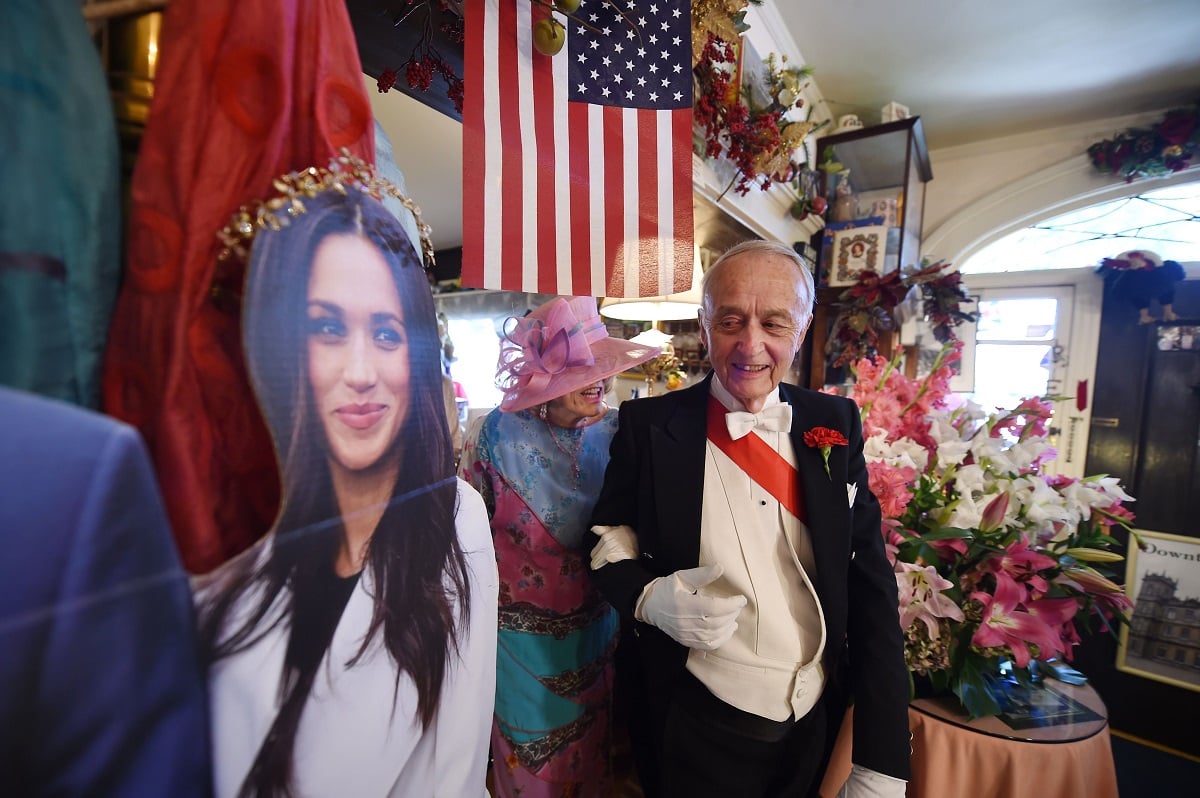 Edmund Fry leads guests past a cardboard cutout of Meghan Markle