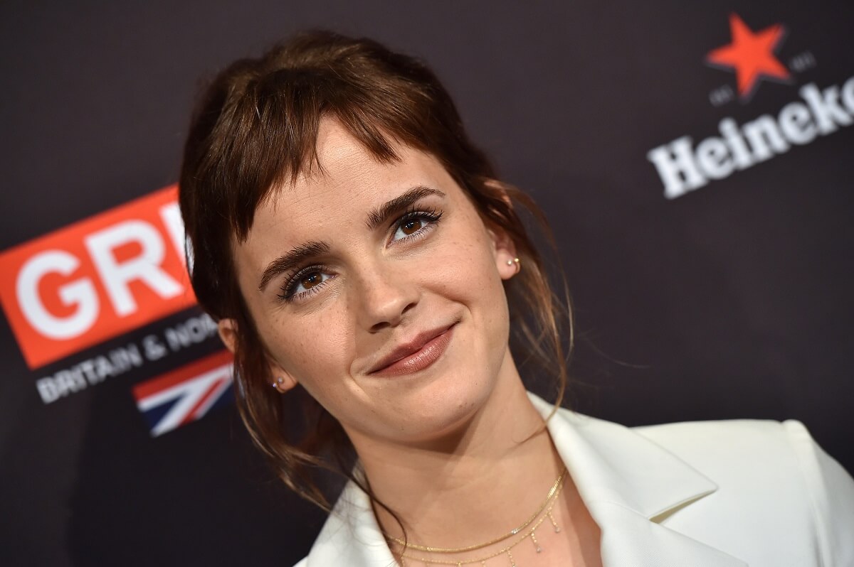 Emma Watson posing in a white suit at The BAFTA Los Angeles Tea Party.