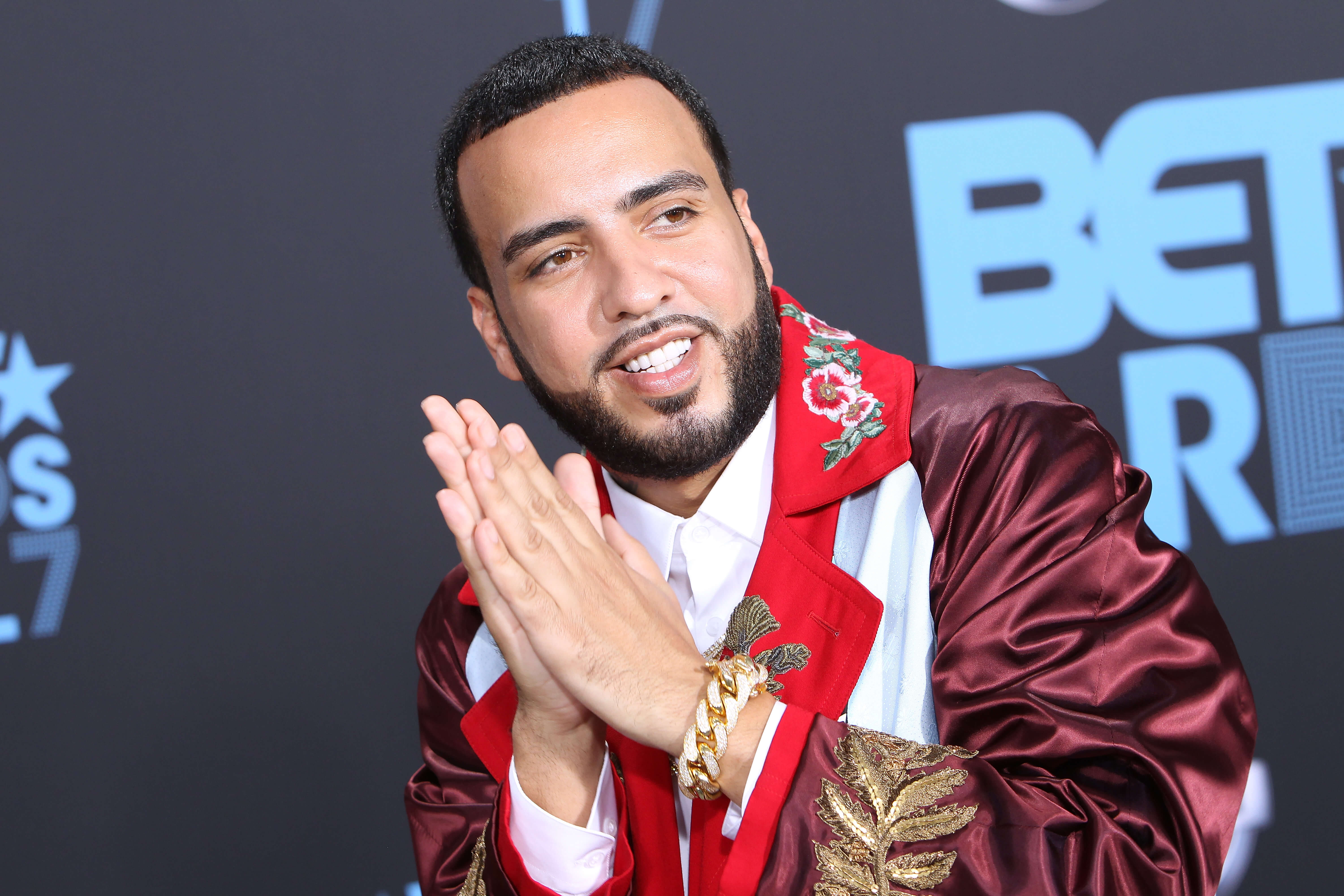 French Montana holding his hands in a prayer formation.