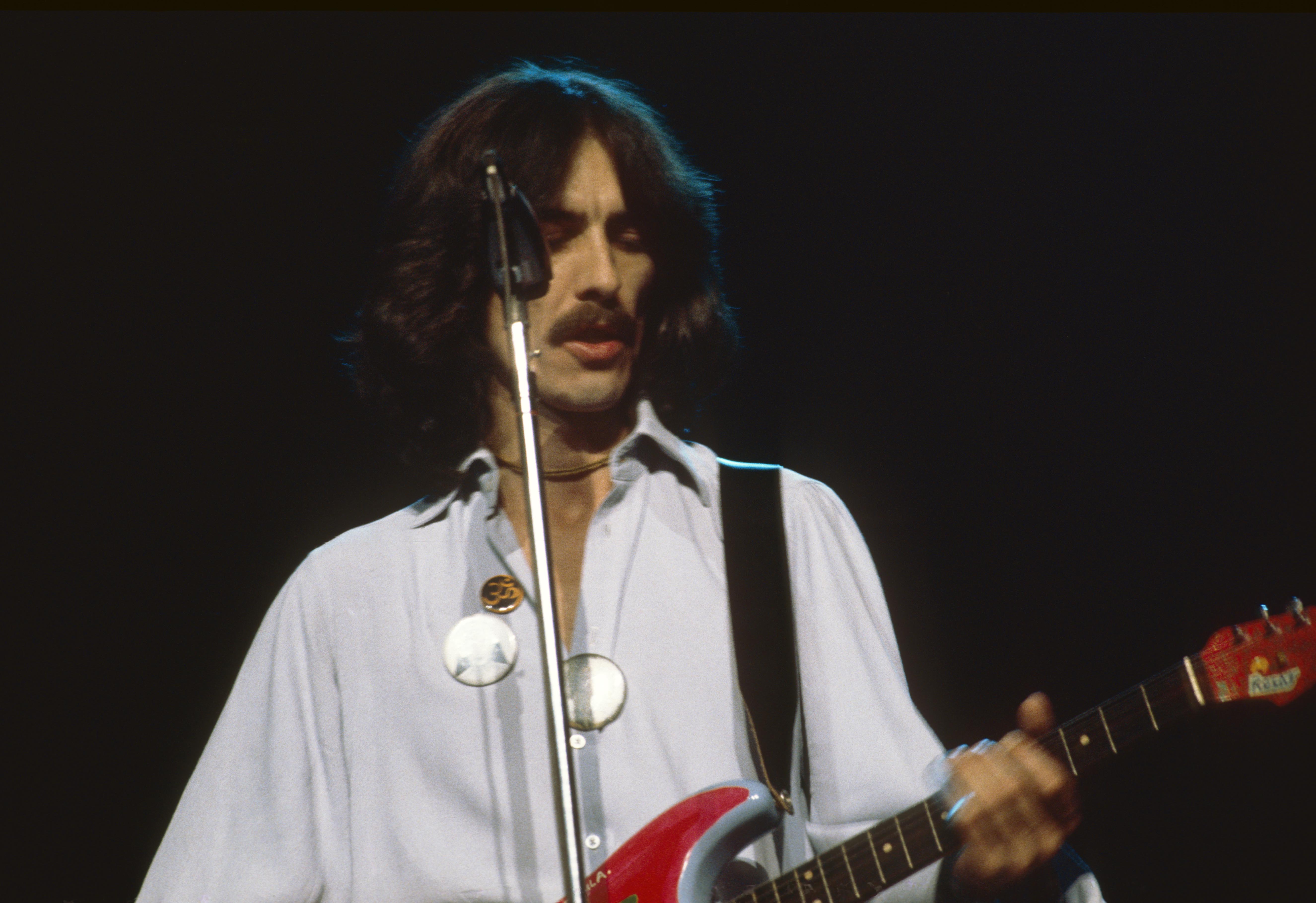 George Harrison performs during his Dark Horse tour