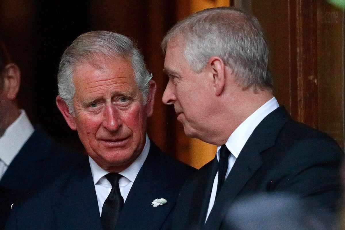 Prince Andrew, whose Order of the Garter honor won't be removed, according to a commentator, stands with King Charles III