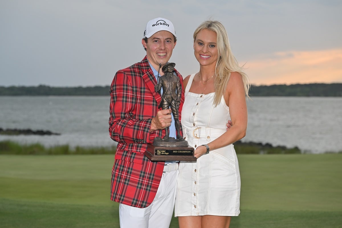 Golfer Matthew Fitzpatrick of England holding trophy with girlfriend Katherine Gaal